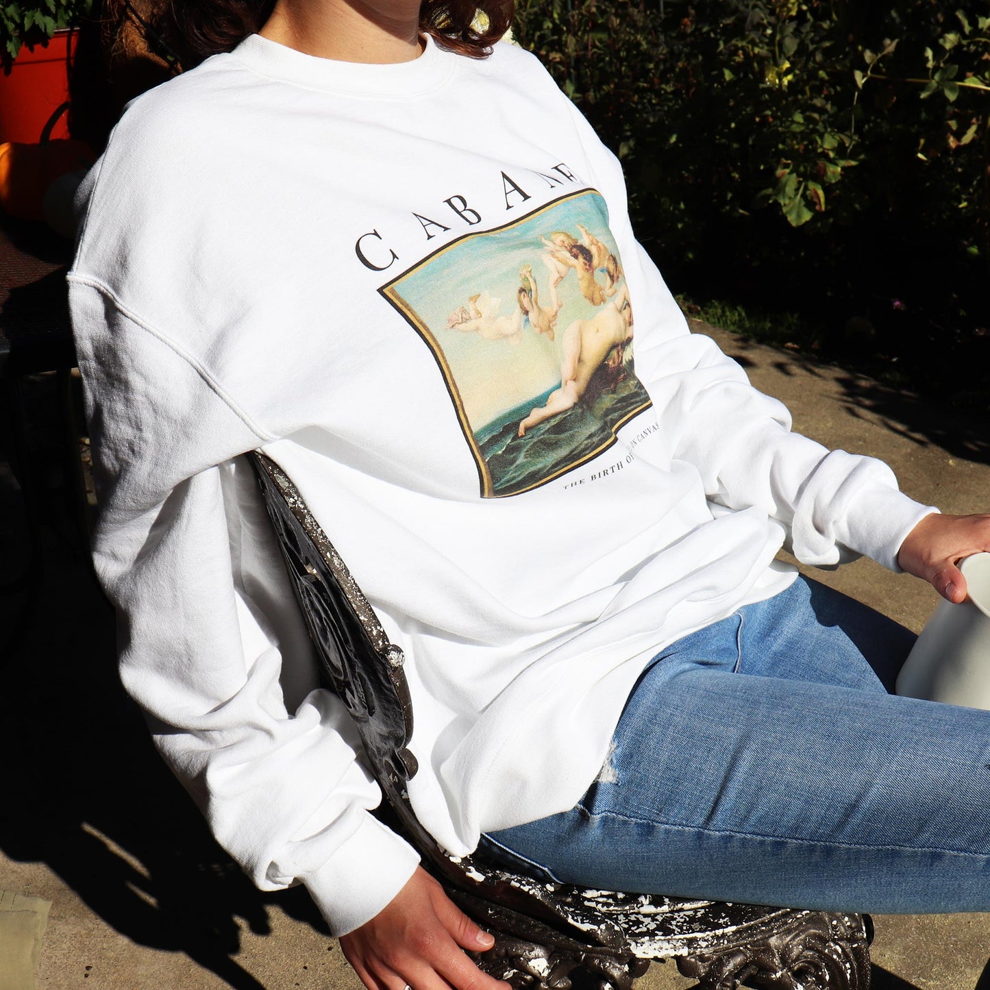 Woman wearing birth of venus sweatshirt in white. whitey baldwin home - wearable art