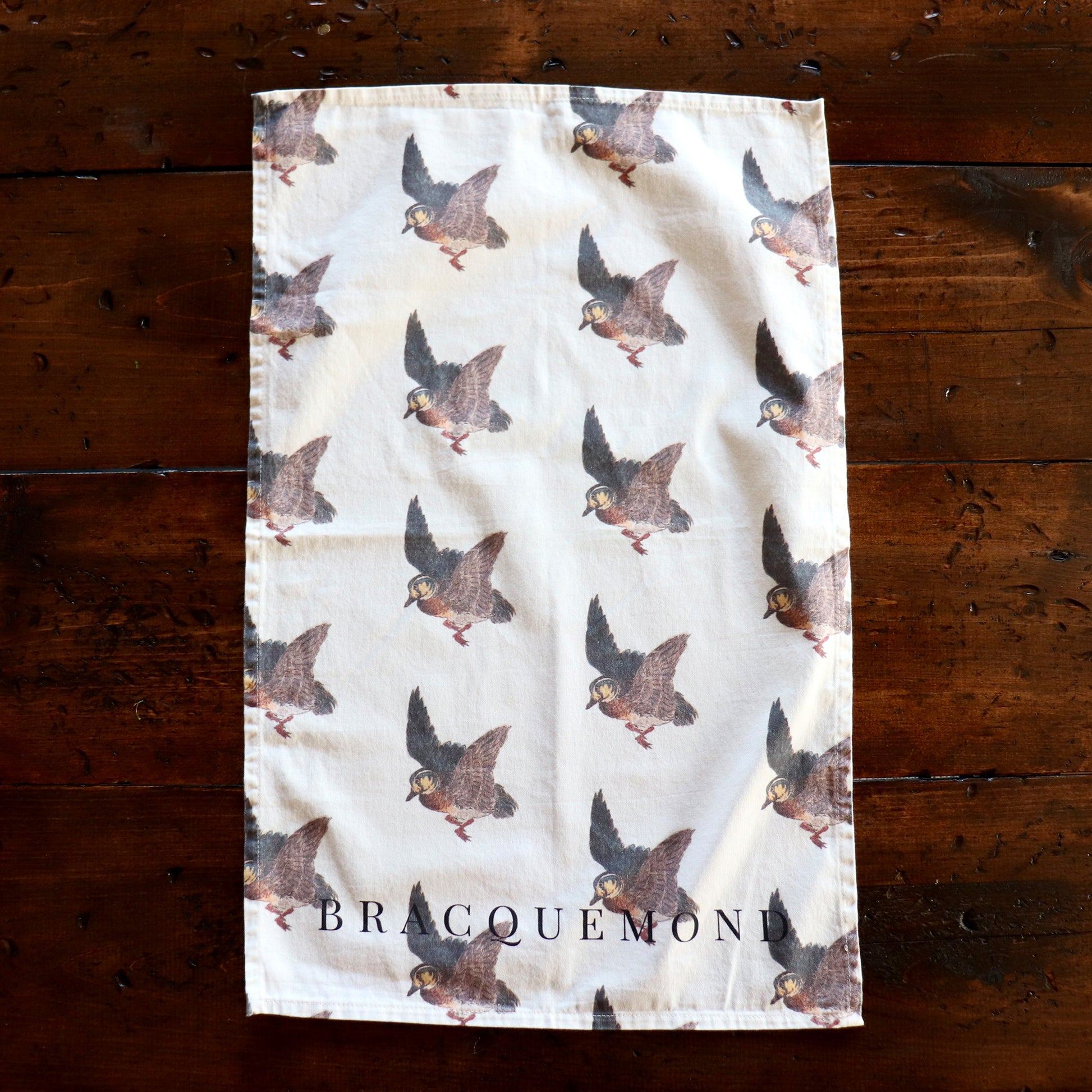 Handmade cotton kitchen towel featuring Felix Bracquemond’s bird and winter scene artwork, perfect for drying dishes or adding a touch of art to your space