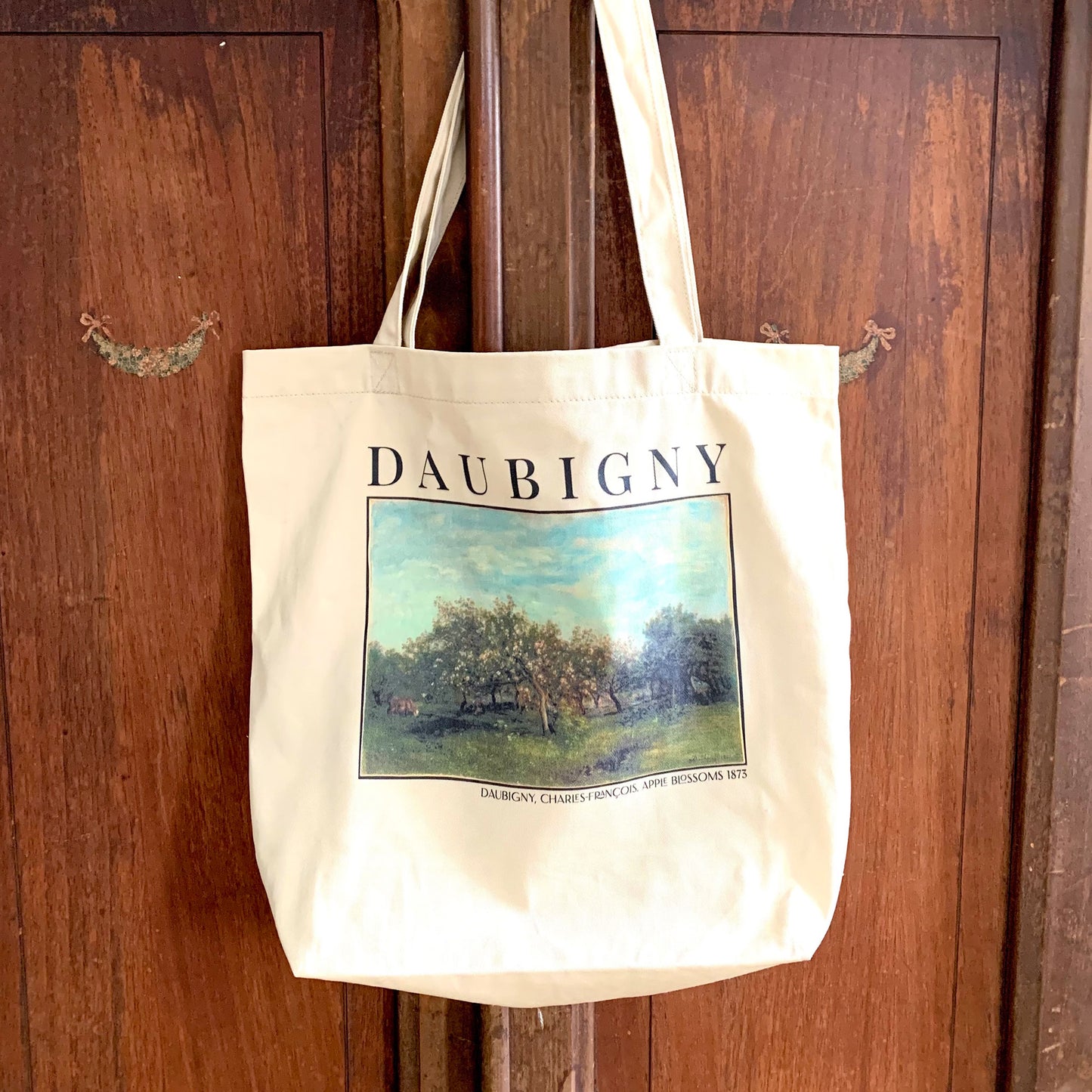 Charles-Francois Daubigny Eco Tote Bag. This market bag is hanging on a door displaying the print