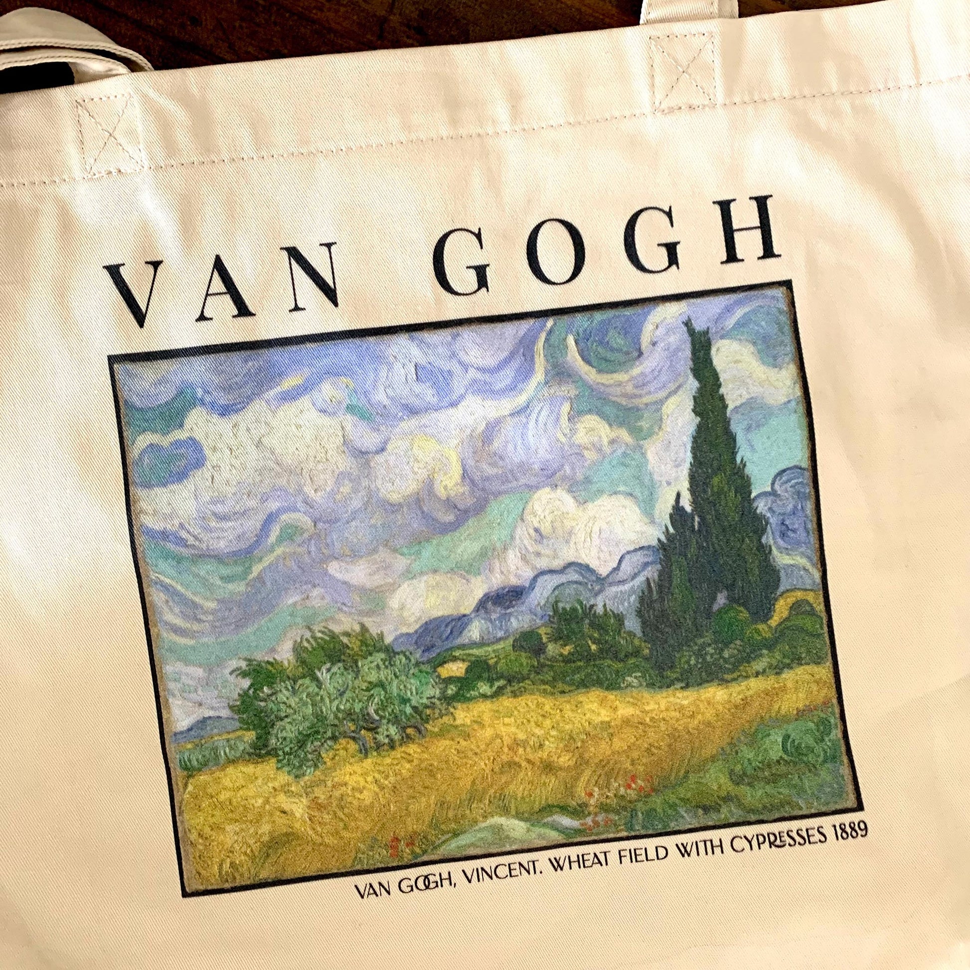 Vincent van Gogh Wheat Field With Cypresses print on an eco friendly market tote bag. beautifully printed art bag